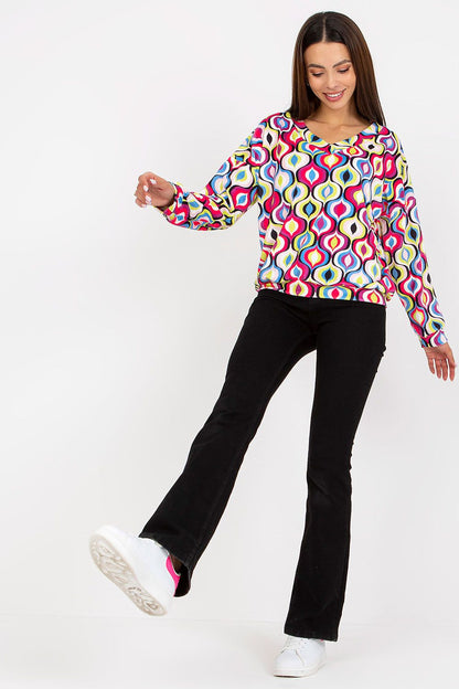 Luxurious Women's Sweatshirt with Heart Neckline and Unique Pattern by Rue Paris, model joyfully stepping in chic attire with vibrant sweatshirt and flared jeans, radiating elegance.