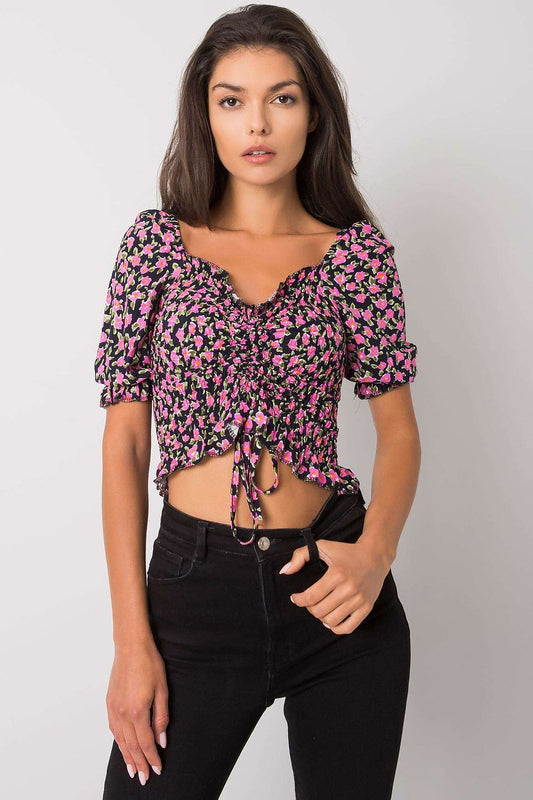 Elegant Fitted Short Sleeve Blouse with V-Neck and Creases by Rue Paris, featuring a floral design and flattering fit, modelled alongside black high-waisted jeans.
