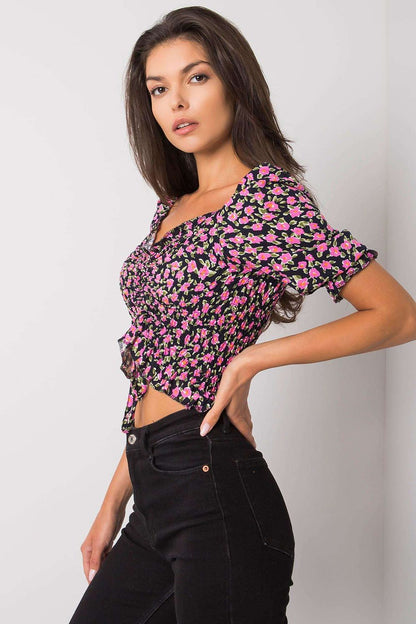 Elegant Fitted Short Sleeve Blouse with V-Neck and Creases by Rue Paris, showcasing a sophisticated floral pattern and styled with black high-waisted jeans, positioned from a side view.