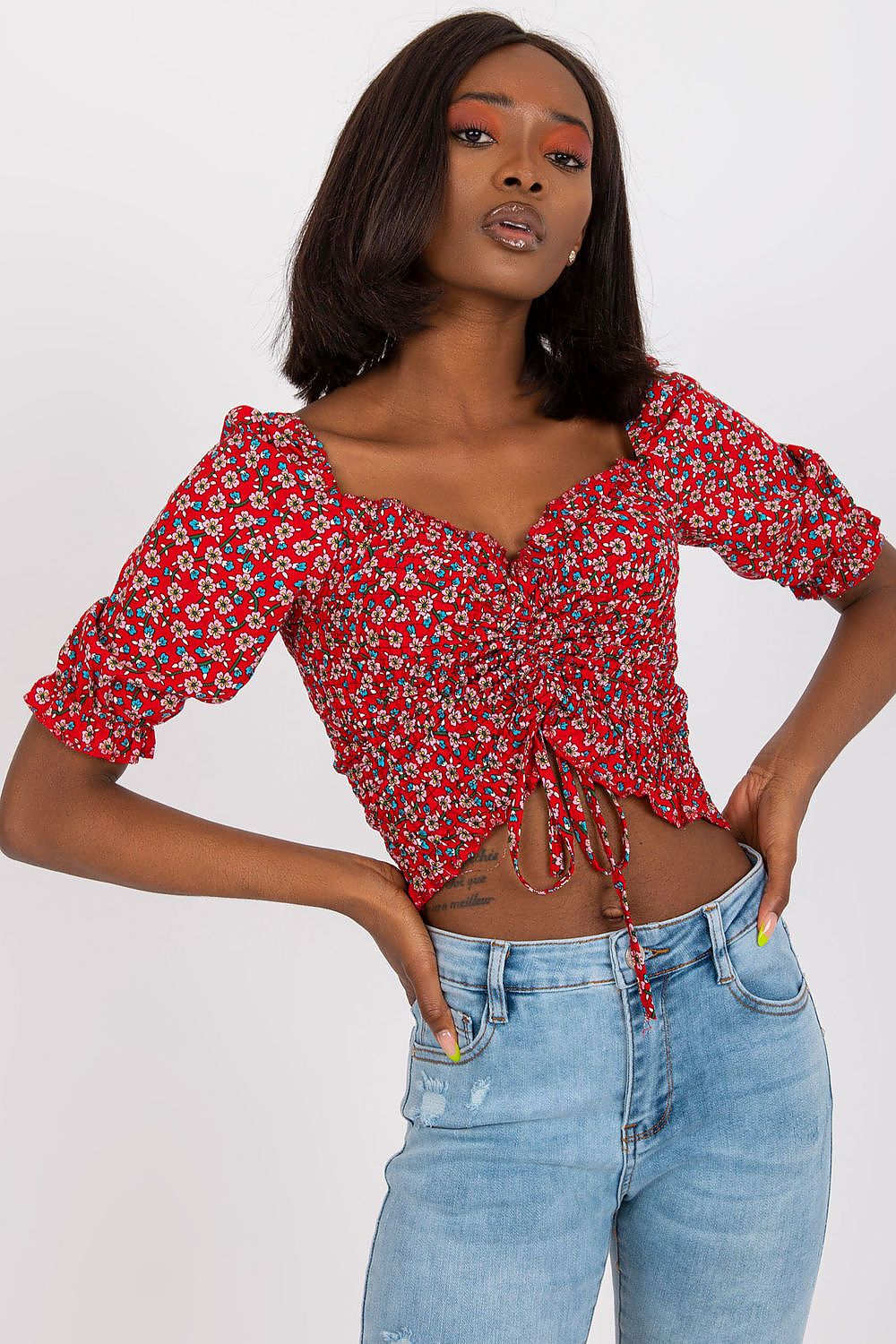 Elevate your style with the fitted short sleeve v-neck blouse in 100% viscose by Rue Paris, featuring a vibrant floral pattern and a trendy cropped cut.