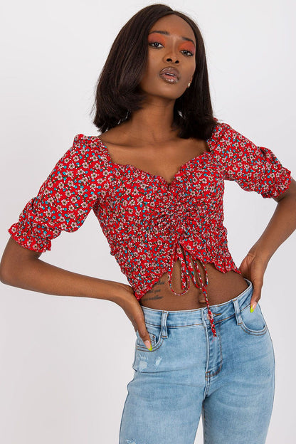 Elevate your style with the fitted short sleeve v-neck blouse in 100% viscose by Rue Paris, featuring a vibrant floral pattern and a trendy cropped cut.