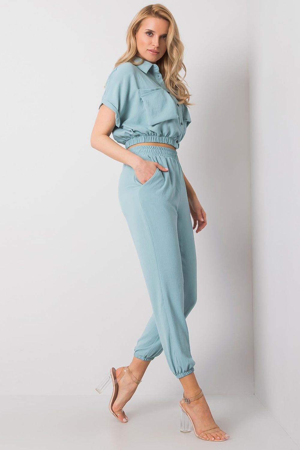 Rue Paris Women's Elegant Trousers Set elegantly displayed with a short-sleeve blouse and flattering waist-fitting trousers in a chic light blue, emphasizing comfort and style for upscale occasions.