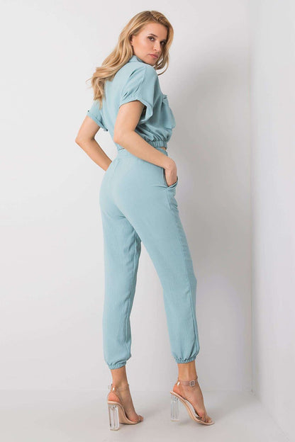 Rue Paris Women's Elegant Trousers Set with Blouse and Pockets - Comfortable and Stylish. A model showcases the exquisite set featuring a chic blue blouse with short sleeves and relaxed-fit trousers with elastic waistband and side pockets, epitomising modern sophistication.