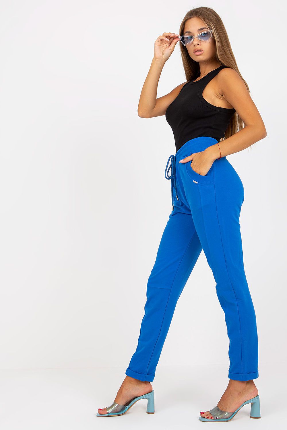 Luxury Women's High-Waisted Sweatpants with Slip Pockets, showcasing a model in stylish blue sweatpants paired with a black top and fashionable accessories.