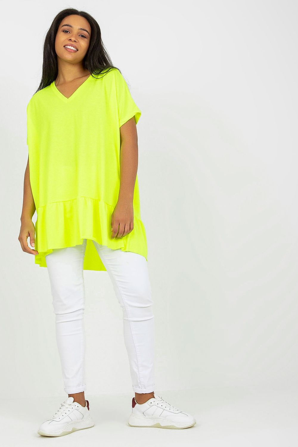 Elegant Plus Size Asymmetrical Tunic with Heart Neckline and Frill, Short Sleeves, showcased in vibrant neon yellow, styled with white slim-fit trousers and sneakers, exemplifying contemporary plus size fashion.