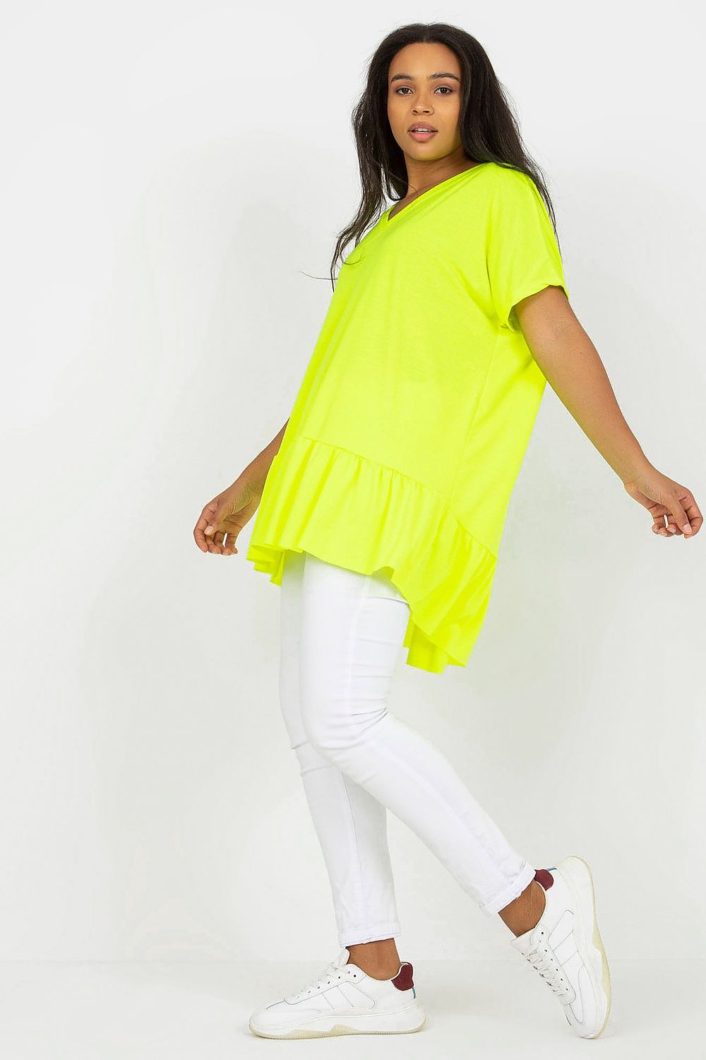 Elegant Plus Size Asymmetrical Tunic with Heart Neckline and Frill, Short Sleeves, featured in an eye-catching neon yellow, paired with chic white jeans and stylish sneakers, representing modern luxury in plus size clothing.