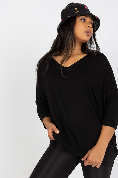 Elegant Plus Size Blouse With 3/4 Sleeves And Sweetheart Neckline, showcased by a model in a chic black outfit, accentuated with a stylish bucket hat.