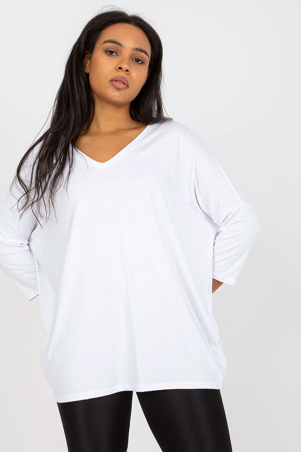 Elegant Plus Size Blouse With 3/4 Sleeves And Sweetheart Neckline, shown on a model wearing a sophisticated white blouse paired with shiny black leggings.
