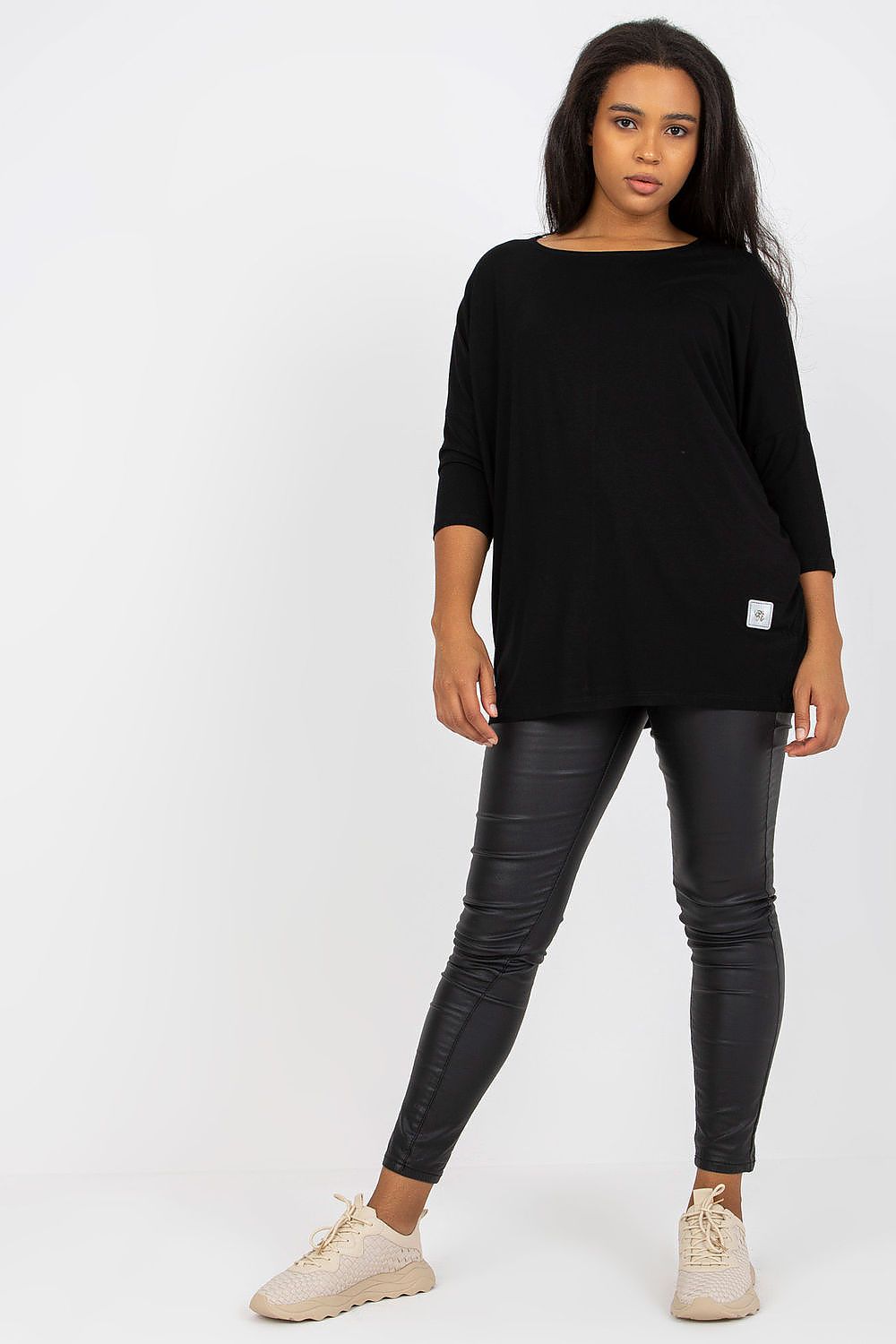 Luxury Plus Size Blouse with 3/4 Sleeves and Boat Neckline in Cotton and Spandex Blend, model posing in black outfit featuring the blouse and slim-fit pants.