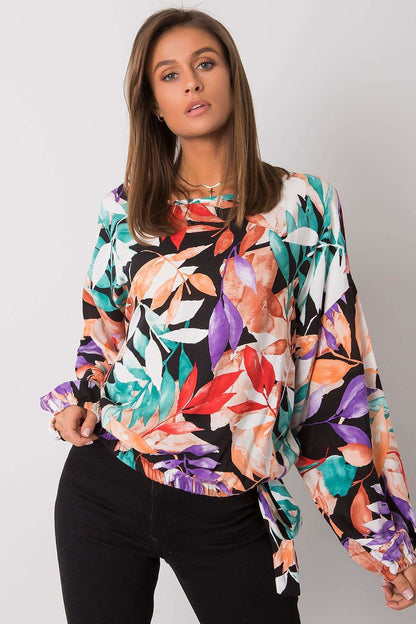 Ex Moda Loose Fit Long Sleeve Blouse with Round Neckline and Decorative Binding, featuring a vibrant floral pattern in shades of red, orange, purple, and teal, showcased on a model in an elegant pose against a minimalist background.