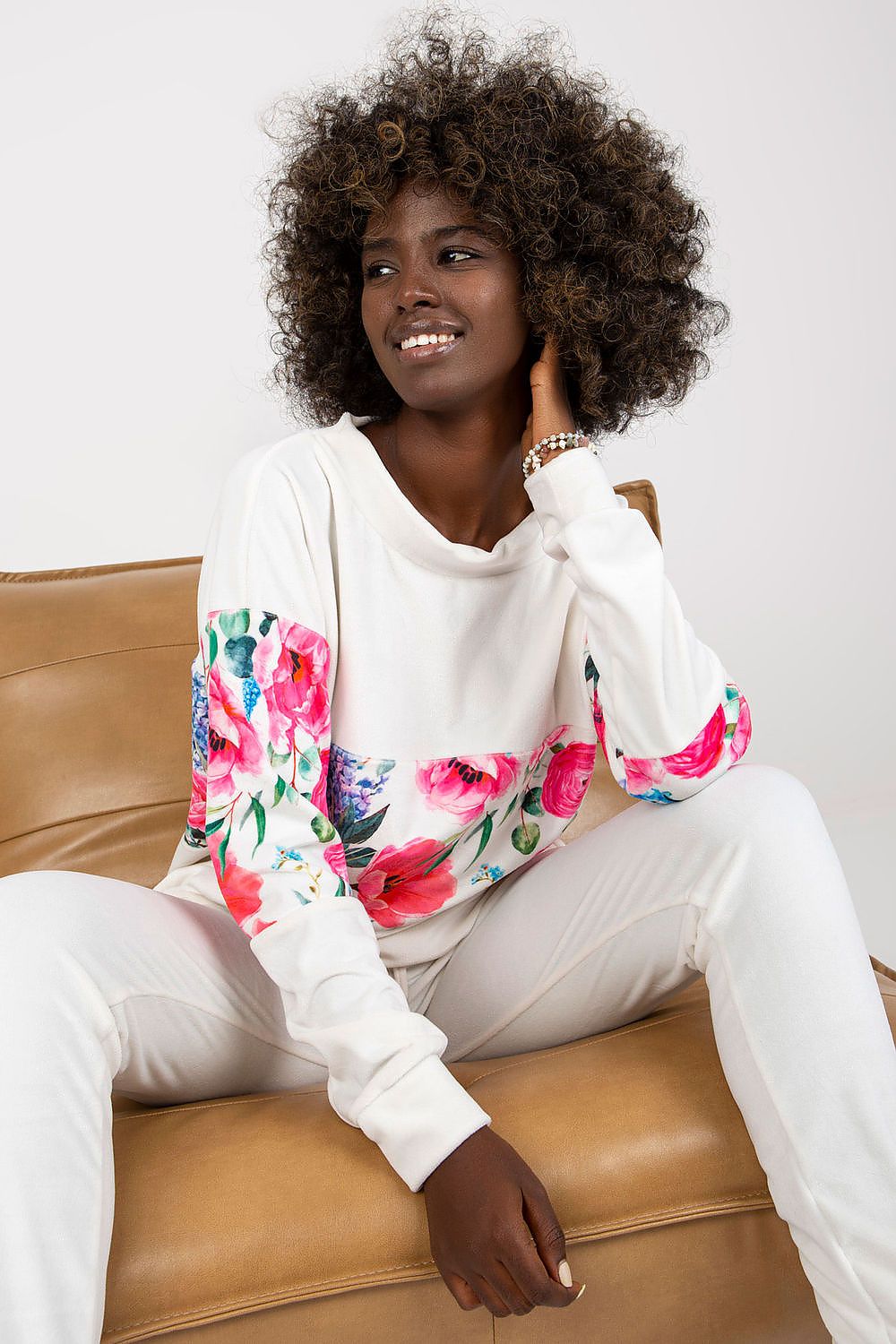 Chic Rue Paris 2-Piece Set showcasing an exquisite long sleeve floral sweatshirt paired with refined long trousers, artfully captured on a model in a relaxed pose.