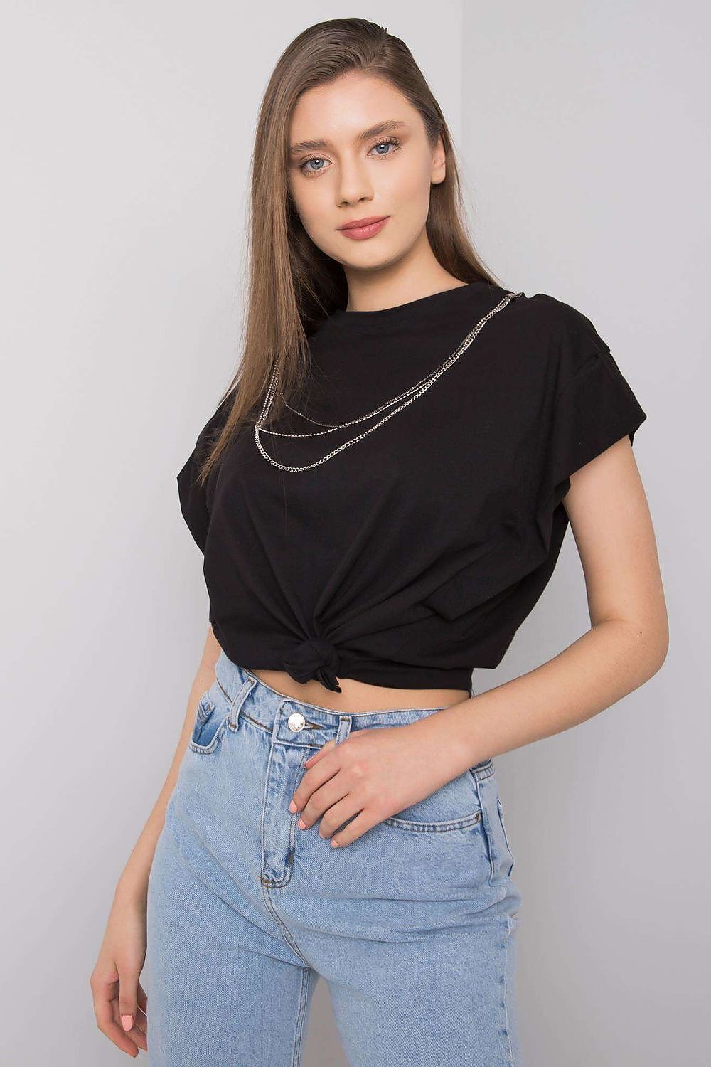 Rue Paris Luxurious Loose Fit Blouse with Short Sleeves & Detachable Chain, elegantly styled with a twist knot at the front, paired with light blue high-waisted jeans, showcasing a casual yet chic look for a sophisticated wardrobe.