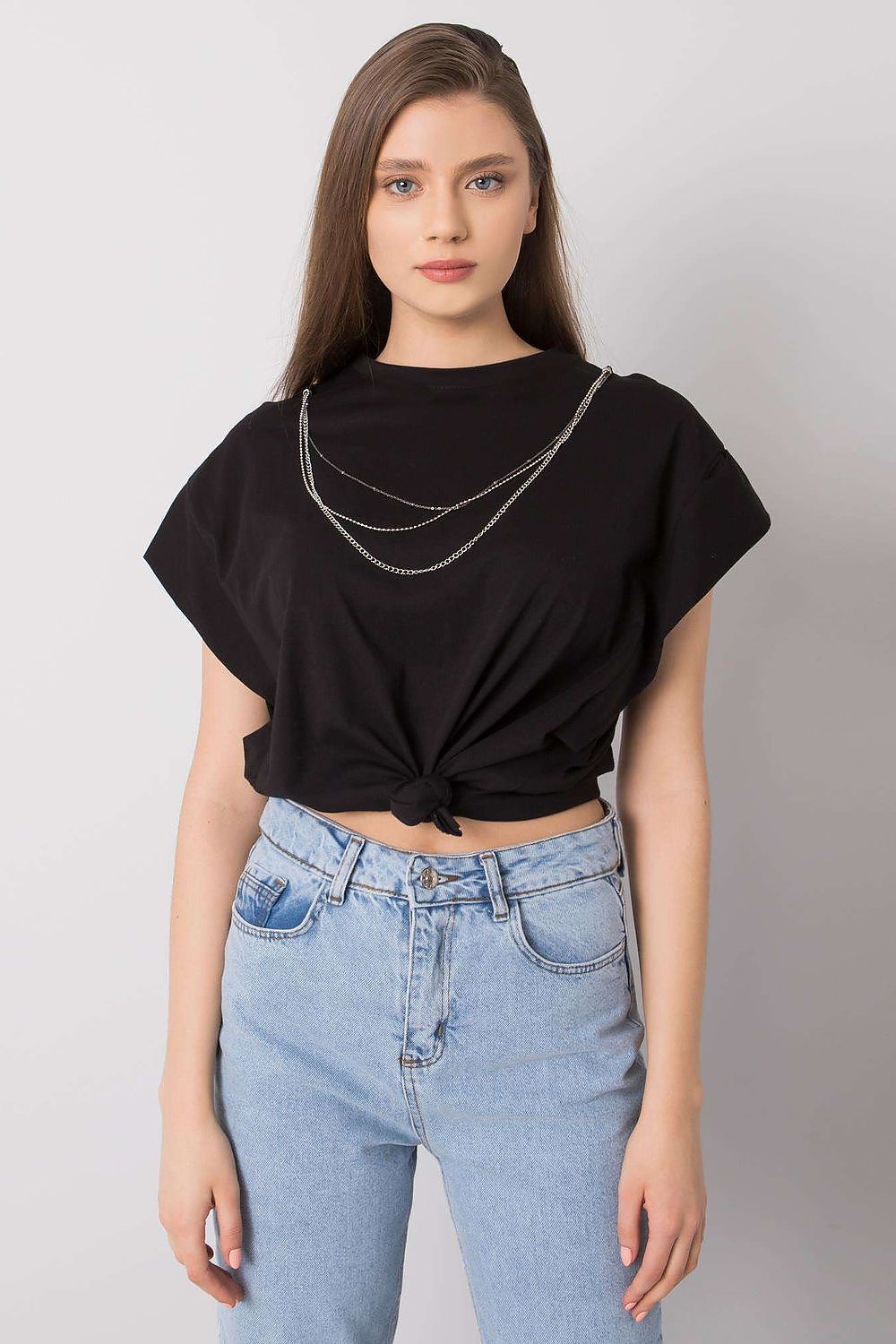 Model showcasing the Rue Paris Luxurious Loose Fit Blouse with Short Sleeves & Detachable Chain, exuding elegance and style, styled with light blue high-waisted jeans, ideal for a fashionable ensemble.