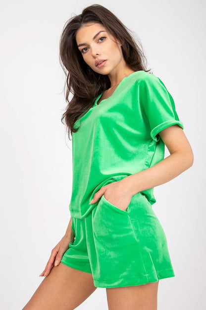 Luxury Velour Blouse And High-Waisted Short Set With Heart Neckline by Rue Paris, featuring a model in a vibrant green velour ensemble, posing confidently with a stylish expression.