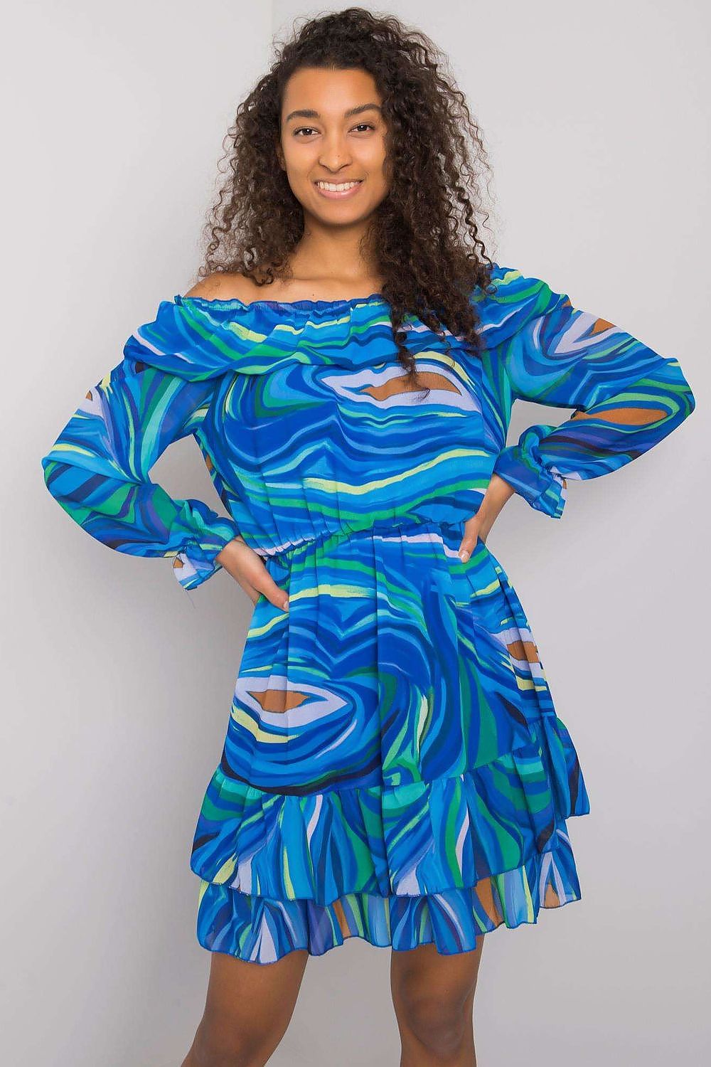 Stunning elegant long sleeve dress with frill hem and Spanish neckline by Italy Moda, showcased on a model with curly hair and a joyful smile, featuring a vibrant blue and green abstract pattern, ideal for a chic summer outing.