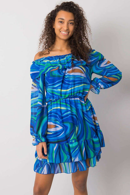 Model showcasing an Elegant Long Sleeve Dress with Frill Hem and Spanish Neckline by Italy Moda, featuring vibrant blue swirls and off-the-shoulder design.