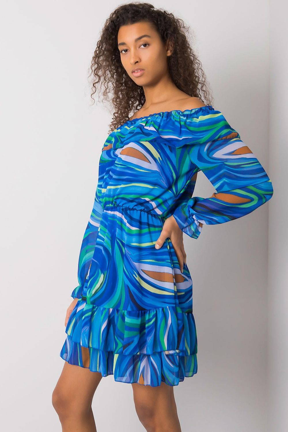 Side view of a chic model in an Elegant Long Sleeve Dress with Frill Hem and Spanish Neckline by Italy Moda, adorned with a stunning blue marble pattern.