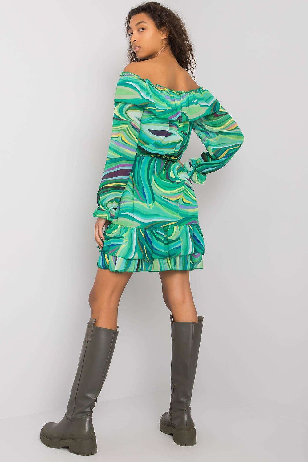 Back view of a fashionable model donning an Elegant Long Sleeve Dress with Frill Hem and Spanish Neckline by Italy Moda, highlighted by its flowing green design and frilly hemline.