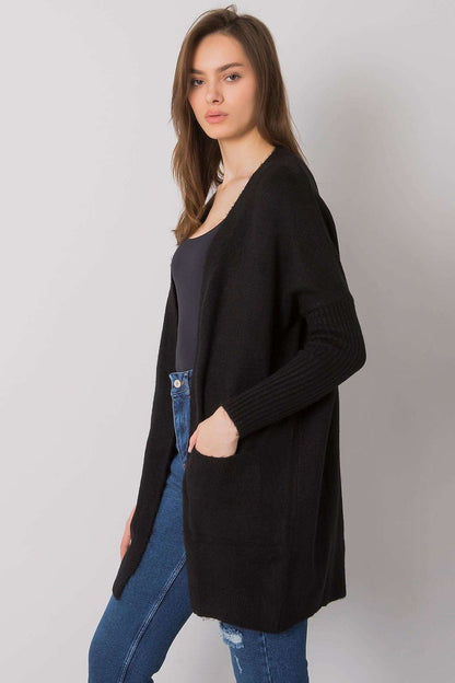 Elegant classic long-sleeve cardigan from Rue Paris with slip pockets, crafted from 75% acrylic for a luxurious touch. Styled in a chic black design, perfect for refined layering.