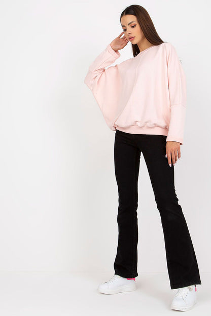 Sophisticated Women's Loose Fit Cotton Spandex Sweatshirt with Round Neckline by Rue Paris in soft pink, elegantly paired with black trousers, exuding relaxed elegance.