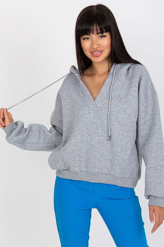 Luxury Women's V-Neck Sweatshirt With Hood - Premium Cotton Blend By BFG, showcased on a model wearing a stylish grey hoodie with a v-neck and ties, paired with vibrant blue trousers, exemplifying comfort and modern fashion.