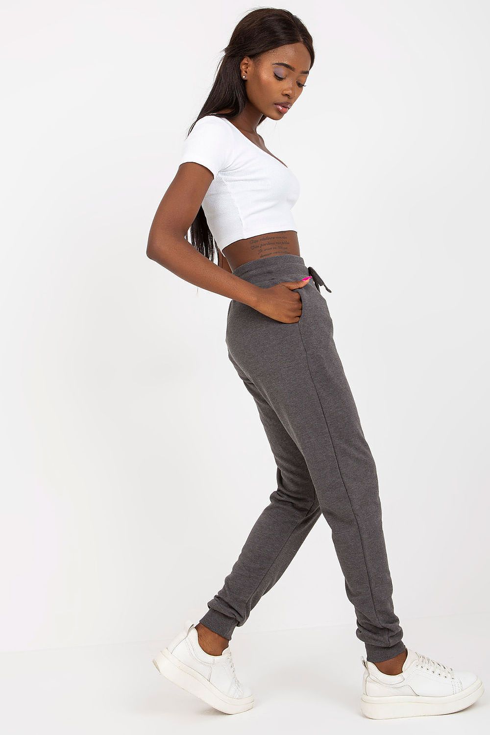 BFG High-Waisted Tracksuit Trousers with Elastic Waistband and Side Slip Pockets. Model displayed in profile, highlighting the sleek fit and luxurious cotton blend of the grey sweatpants.
