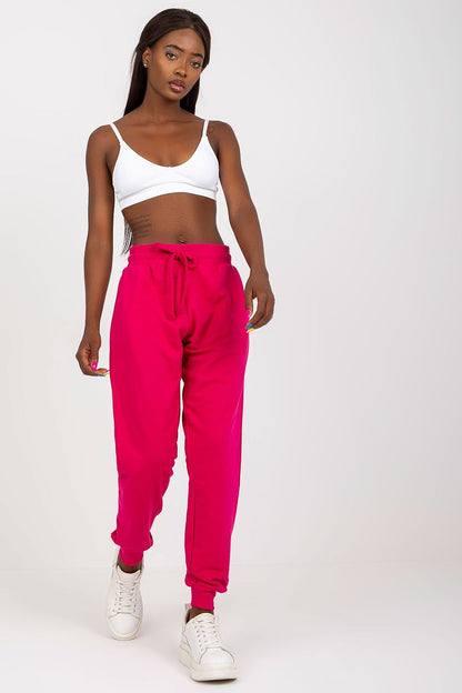 Sophisticated look featuring BFG High-Waisted Tracksuit Trousers with Elastic Waistband and Side Slip Pockets in vibrant pink, paired with a white bralette for a trendy casual outfit.
