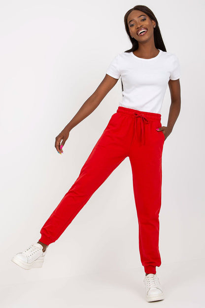 Stylish model displaying the vibrant red BFG high-waisted sweatpants with elastic waistband and side pockets, set against a clean background.