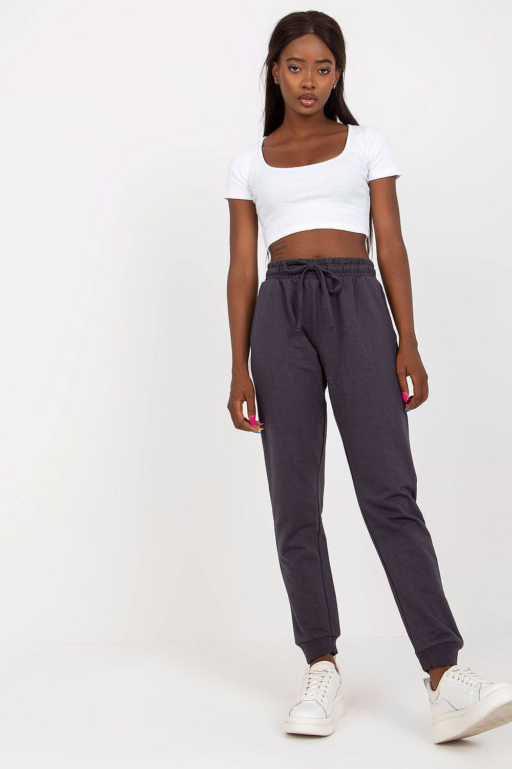 Refined BFG High-Waisted Sweatpants in dark grey cotton blend, featuring a tie waist and stylish side pockets, modelled with a trendy white crop top.