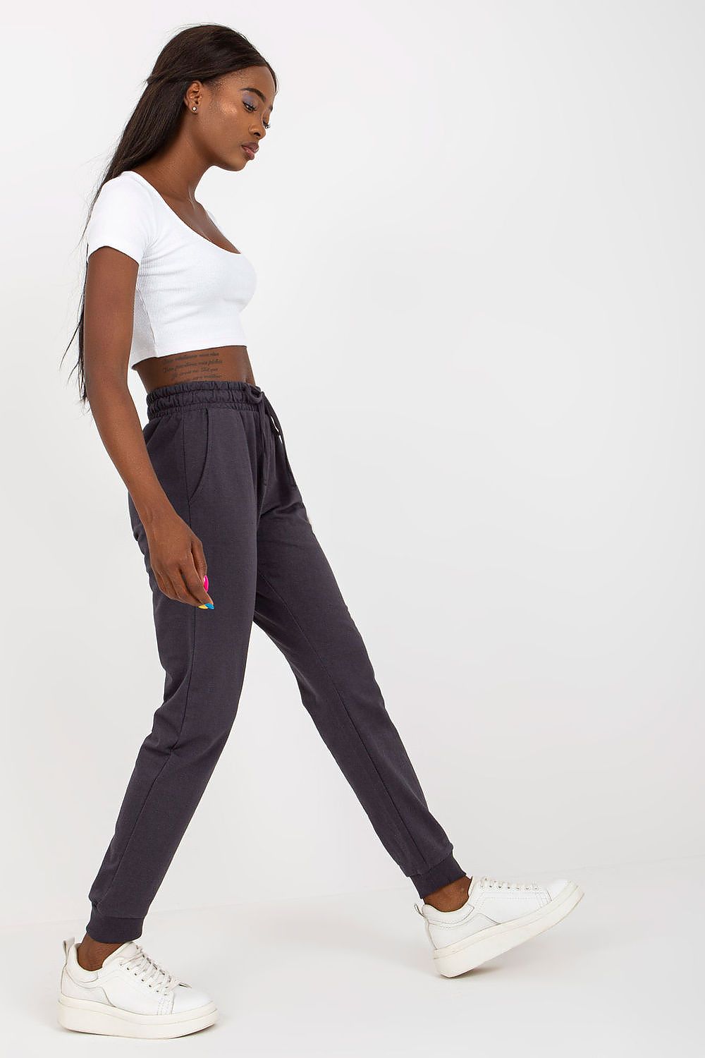 Sophisticated BFG High-Waisted Sweatpants in charcoal grey, featuring an elastic waistband and exquisite side pockets, modelled elegantly with a white crop top.