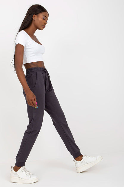 Sophisticated BFG High-Waisted Sweatpants in charcoal grey, featuring an elastic waistband and exquisite side pockets, modelled elegantly with a white crop top.