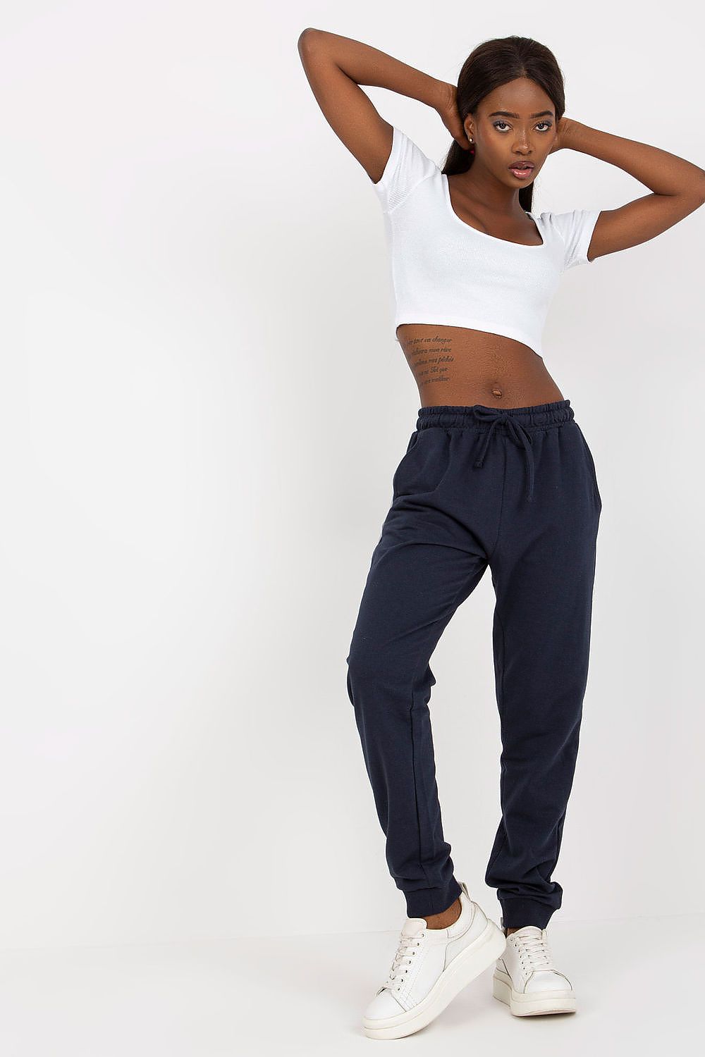 Chic BFG High-Waisted Sweatpants in deep navy, designed with an elastic waistband and side pockets, paired with a stylish white crop top, presenting a luxurious casual look.