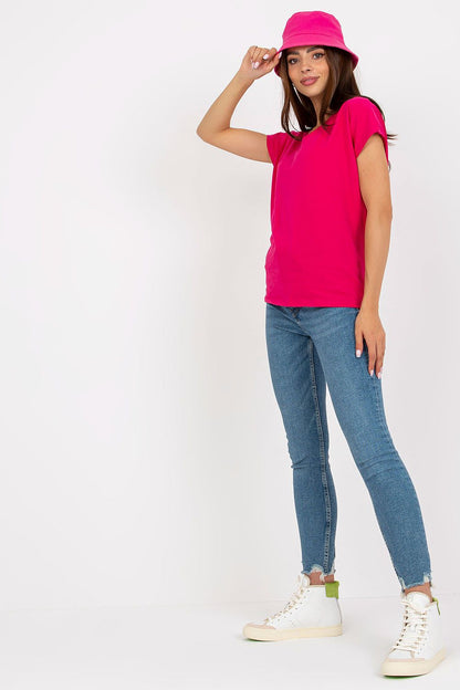 Vibrant Luxurious Heart Neckline T-Shirt in 95% Cotton on a model, complemented by stylish blue denim jeans and a pink bucket hat, exuding a trendy summer vibe.