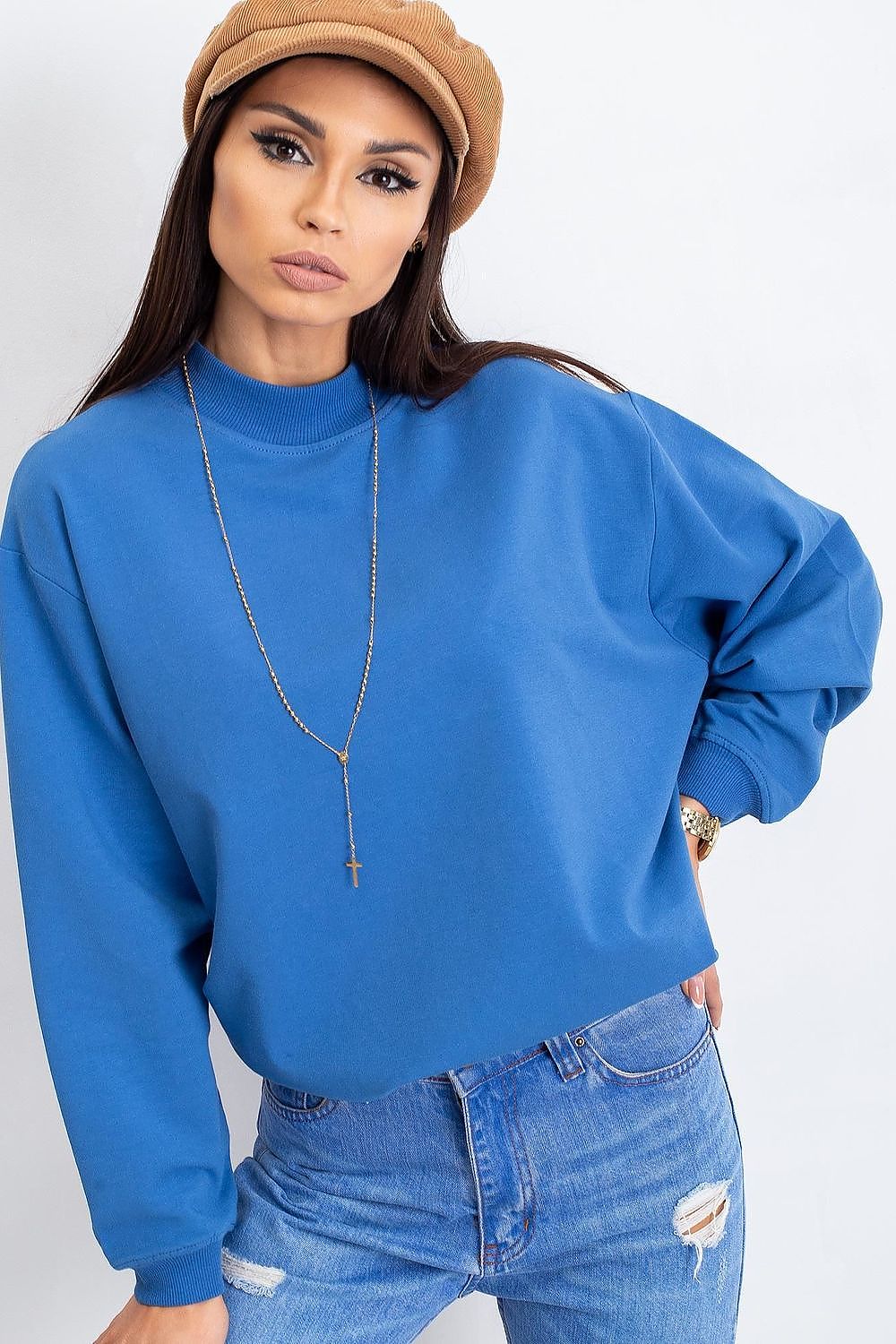 Luxury Women's Cotton Sweatshirt with Stand-Up Collar showcased in a vibrant blue colour, featuring long sleeves and a stylish stand-up collar. The model pairs it with distressed denim, exuding breathable comfort and elegance.