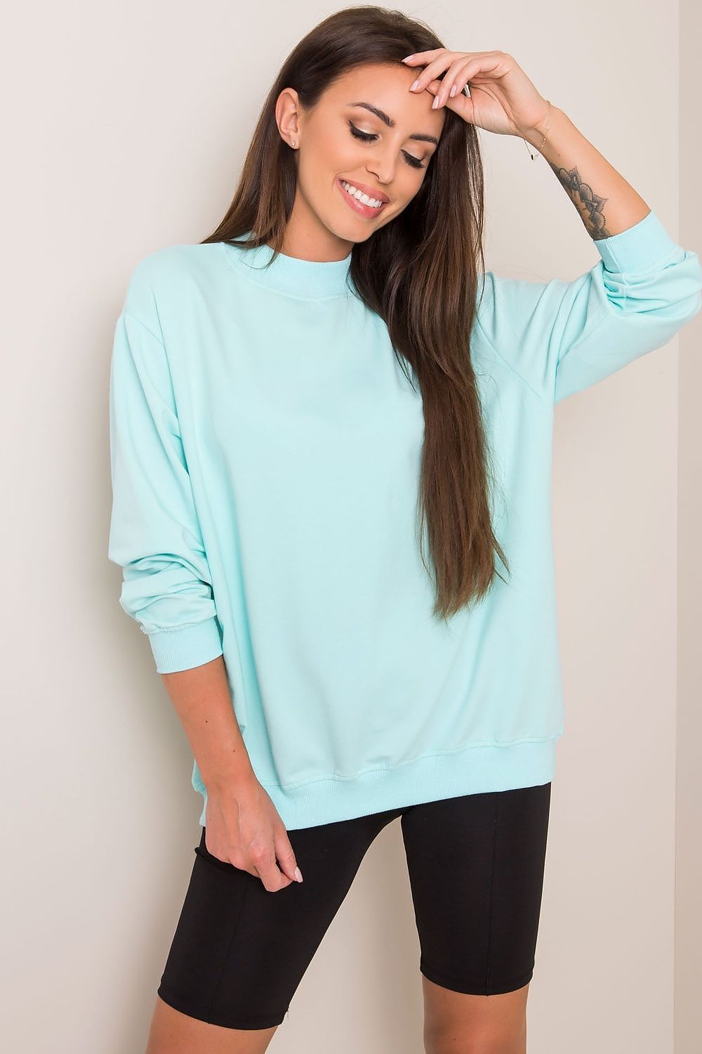 Luxury Women's Cotton Sweatshirt with Stand-Up Collar in mint green, elegantly paired with black bike shorts, radiating a sophisticated sporty vibe.