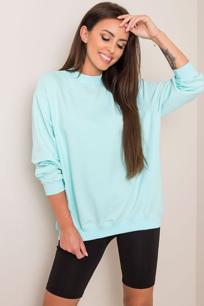 Luxury Women's Cotton Sweatshirt with Stand-Up Collar in mint green, elegantly paired with black bike shorts, radiating a sophisticated sporty vibe.