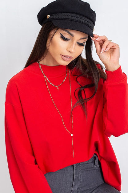 Luxury Women's Cotton Sweatshirt with Stand-Up Collar - Breathable Comfort & Style. Model wearing a red cotton sweatshirt with a stand-up collar, accessorised with a black hat and layered necklaces.