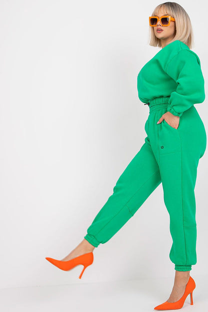 Ex Moda Cotton Blend Sweatshirt Set with High-Waist Trousers – Elegant Loungewear Outfit showcasing a fashionable model in a striking green sweatshirt and matching trousers, elegantly posed with orange heels, exuding a sophisticated loungewear aesthetic.