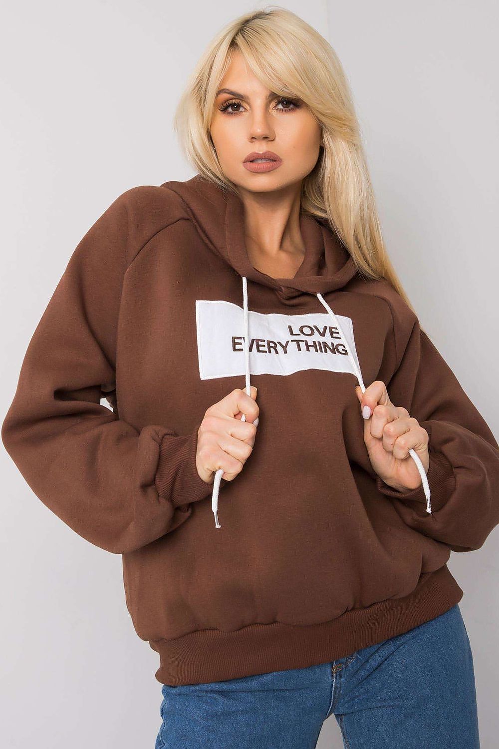 Ex Moda Women's Hooded Sweatshirt - Stylish long sleeve design with decorative inscription, featuring a model showcasing the brown sweatshirt with 'LOVE EVERYTHING' printed on the front.