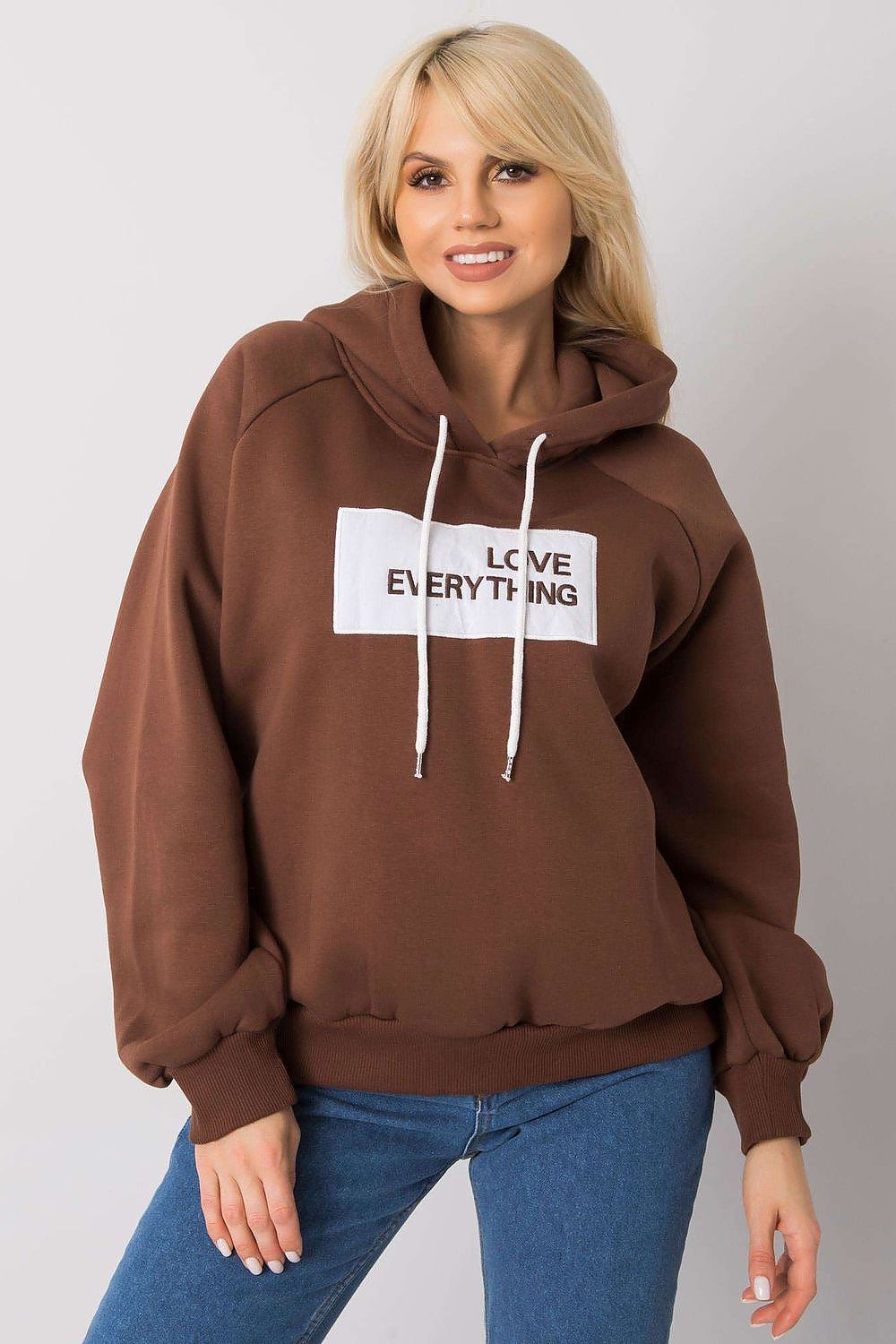 Ex Moda Women's Hooded Sweatshirt - Stylish long sleeve design with decorative inscription, model smiling while wearing a brown hoodie with 'LOVE EVERYTHING' text.