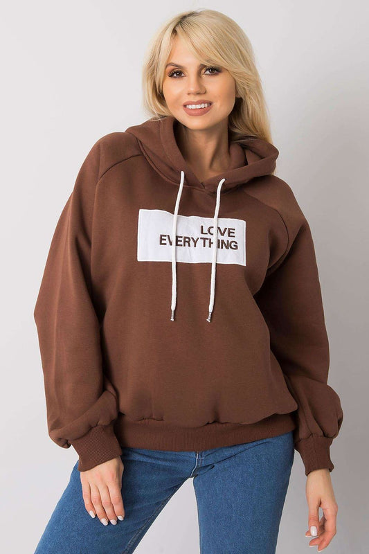 Ex Moda Women's Hooded Sweatshirt - Stylish long sleeve design with decorative inscription, model smiling while wearing a brown hoodie with 'LOVE EVERYTHING' text.
