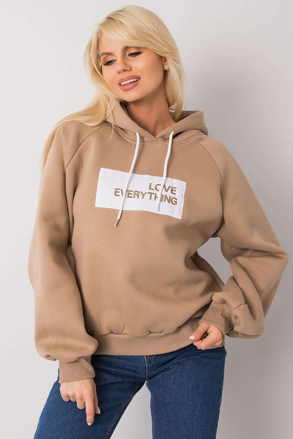 Ex Moda Women's Hooded Sweatshirt - Elegant long sleeve attire adorned with 'LOVE EVERYTHING' inscription, paired with casual denim for a stylish look.