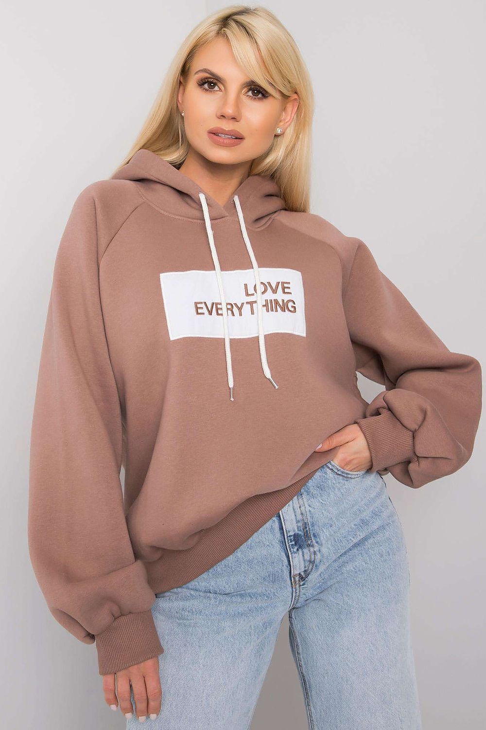 Ex Moda Women's Hooded Sweatshirt - Sophisticated long sleeve hoodie showcasing stylish inscription, complemented by light wash jeans for a modern outfit.