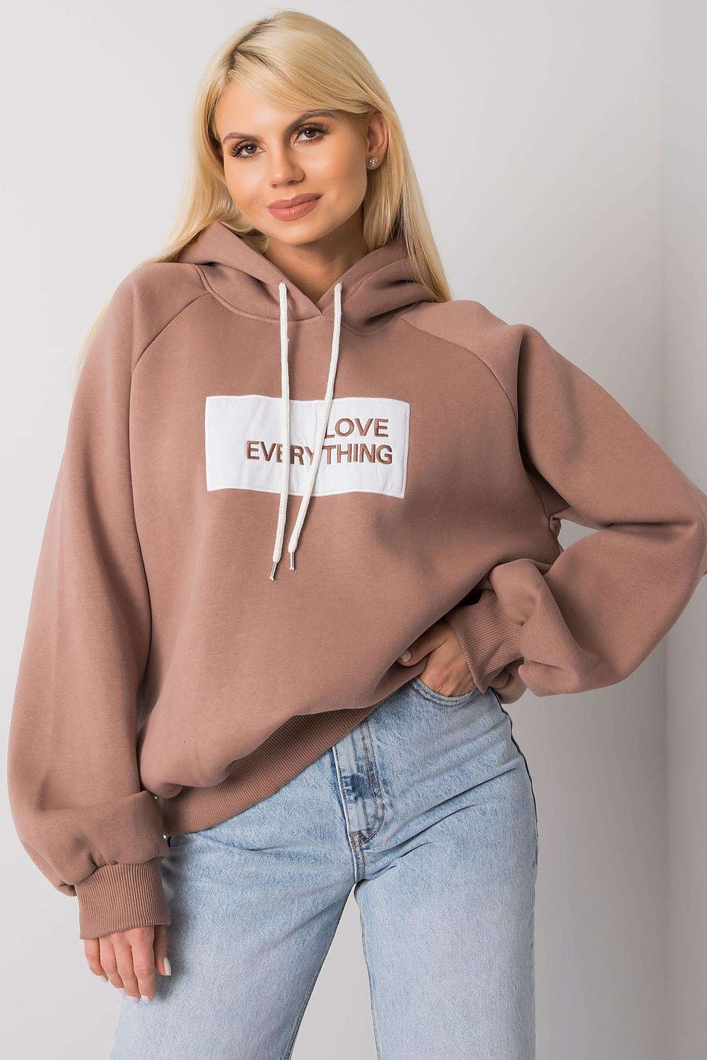 Ex Moda Women's Hooded Sweatshirt - Fashionable long sleeve design featuring unique inscription, paired with vintage jeans for a luxurious casual ensemble.