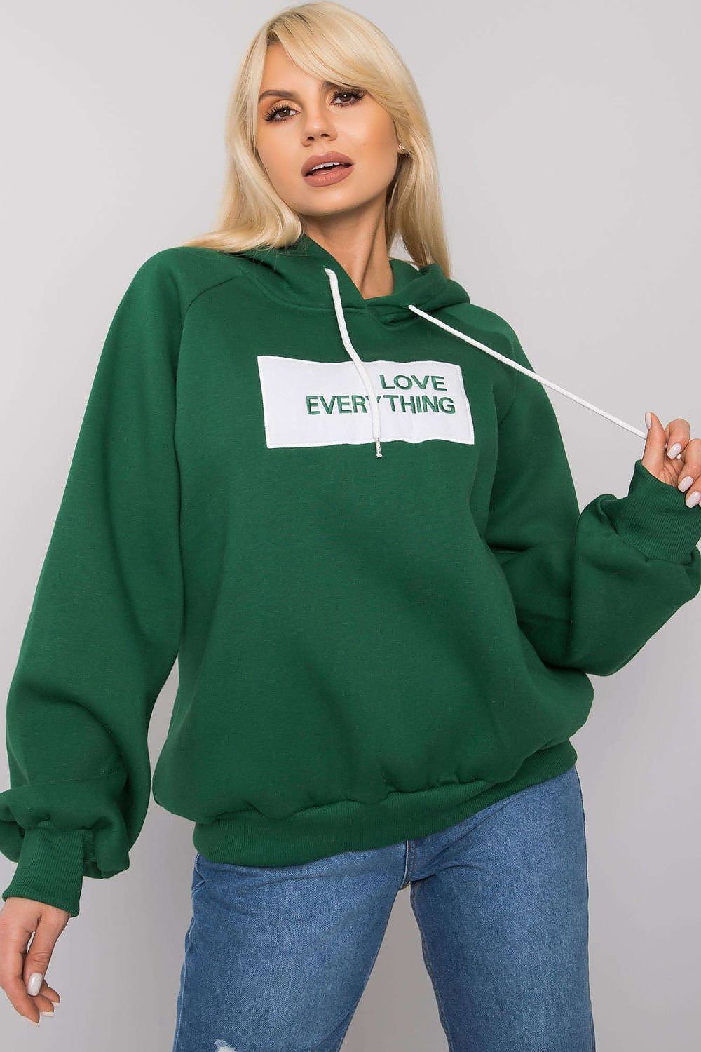 Ex Moda Women's Hooded Sweatshirt in rich green, featuring a motivational 'LOVE EVERYTHING' inscription, styled with a high neckline and cozy long sleeves.