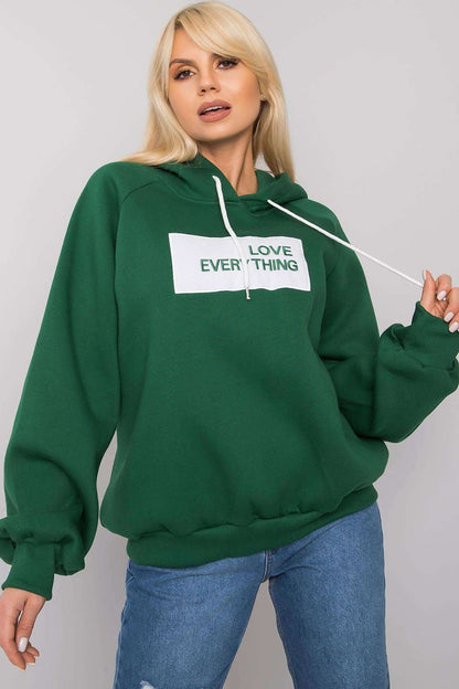 Ex Moda Women's Hooded Sweatshirt in rich green, featuring a motivational 'LOVE EVERYTHING' inscription, styled with a high neckline and cozy long sleeves.