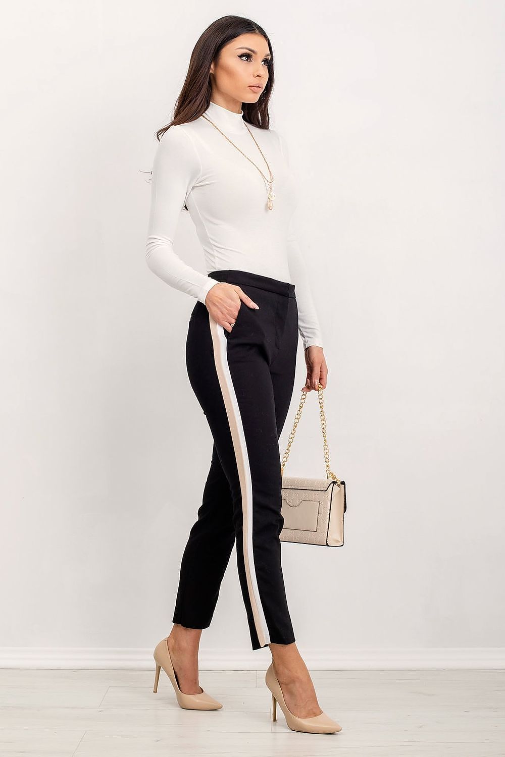 Side view of the Luxury Long-Sleeve Turtleneck by Rue Paris, paired with black trousers, highlighting its refined fit and luxurious fabric.