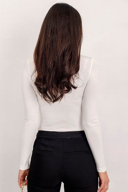 Back view of the Luxury Long-Sleeve Turtleneck by Rue Paris, emphasizing its seamless design and luxurious quality, complemented by sophisticated trousers.