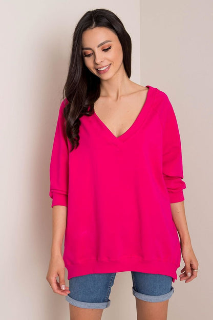 Vibrant Loose Fit Rue Paris Sweatshirt With Heart Neckline in striking pink, elegantly worn with denim shorts. Crafted from a luxurious mix of 90% cotton and 10% spandex.