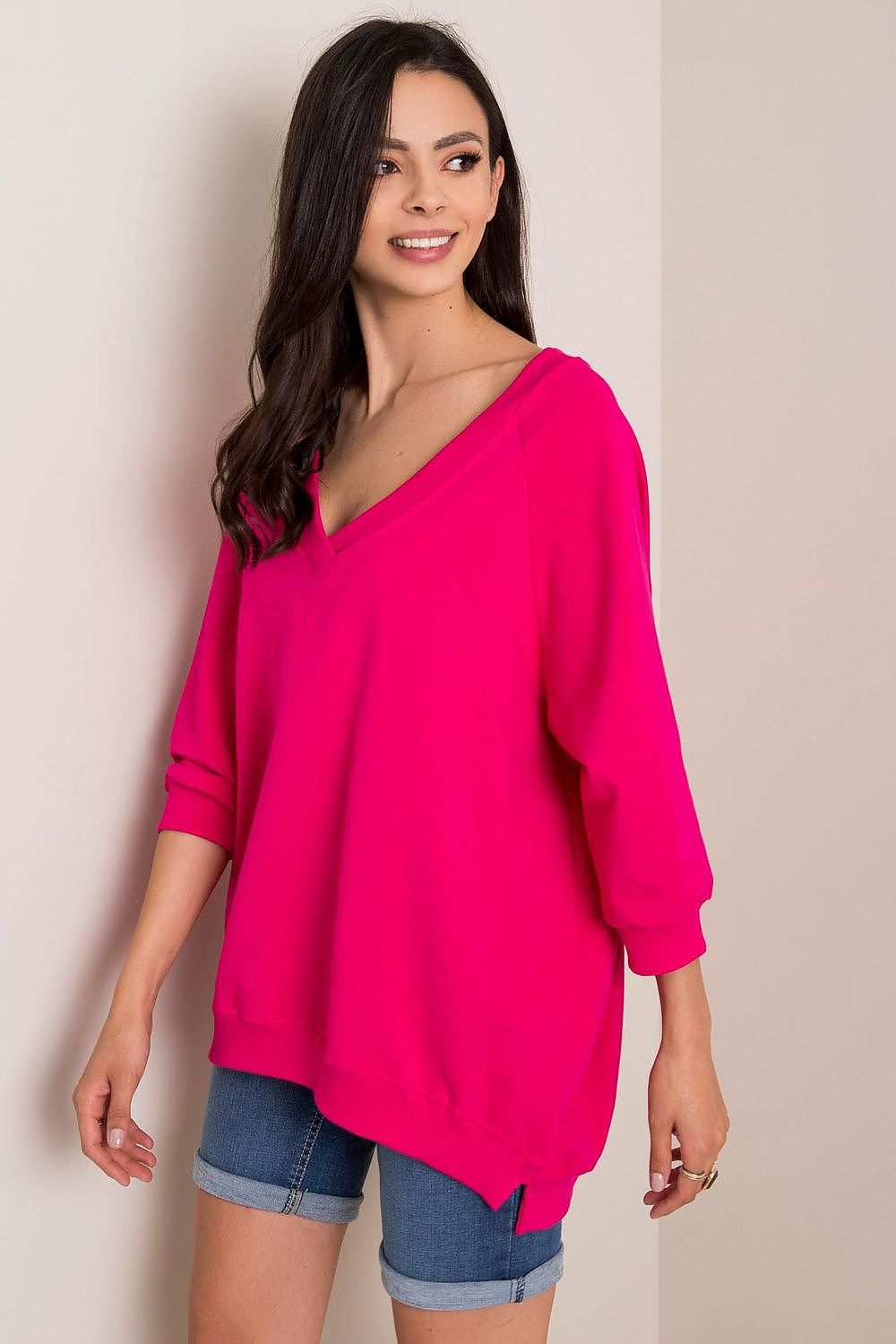 Chic Loose Fit Rue Paris Sweatshirt With Heart Neckline in bold pink, model displaying a stylish and relaxed side angle, made with premium fabric blend of 90% cotton and 10% spandex.